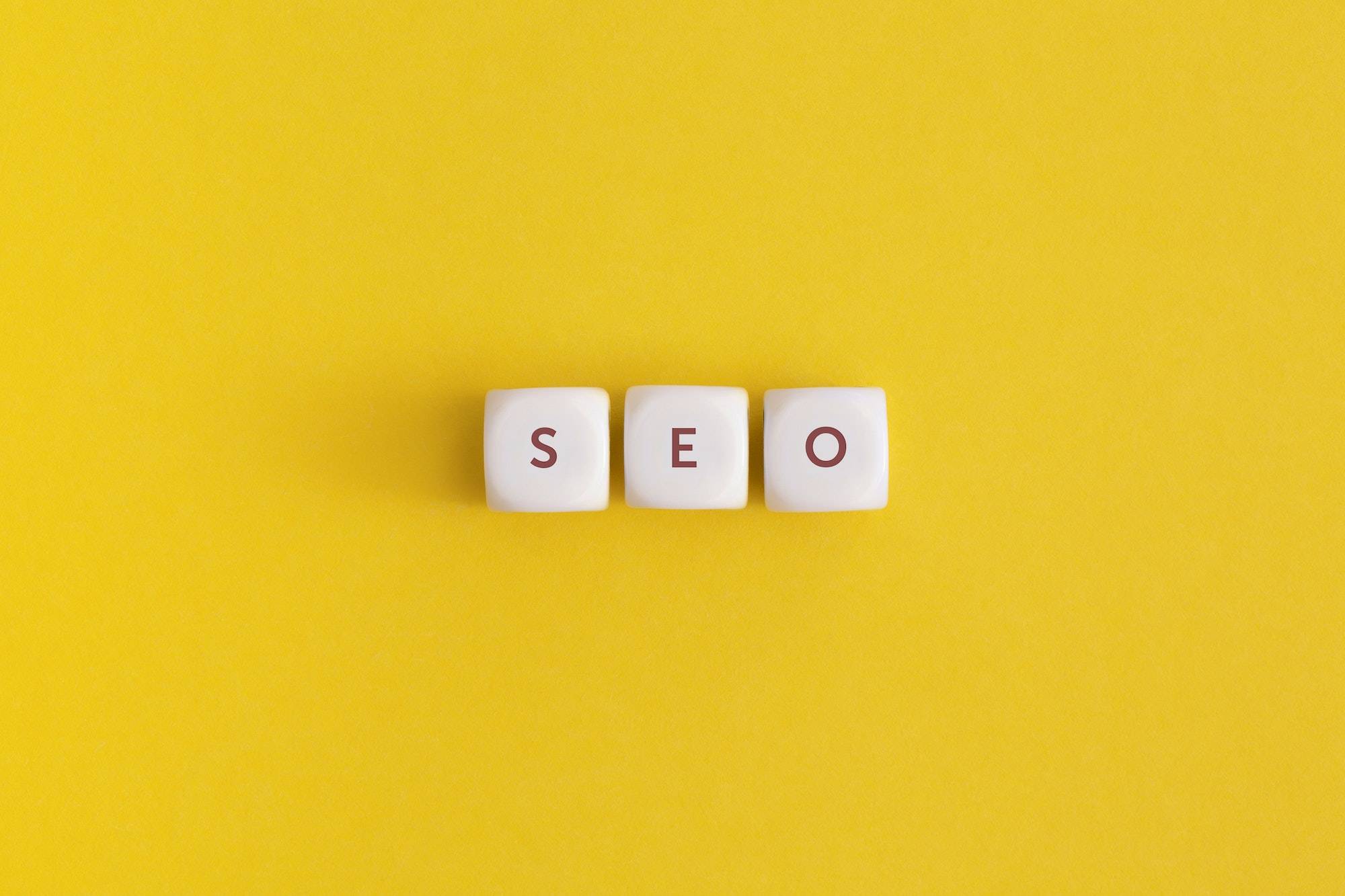 The word seo on yellow background. Top view. Flat lay.
